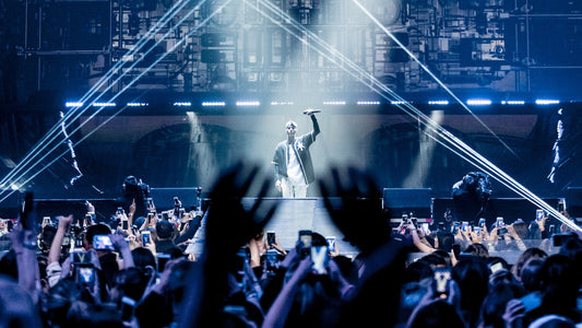 Justin bieber holding a microphoneup on the stage