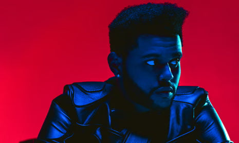 The Weeknd in black leather jacket with dramatic red and blue lighting, gazing to the side.