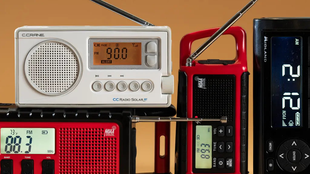 Several portable emergency radios with antennas and digital displays, including weather alert models, shown in different colors and designs.