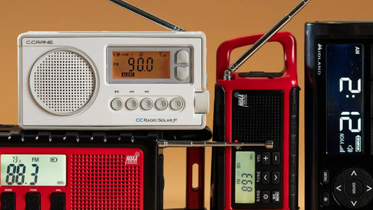 Several portable emergency radios with antennas and digital displays, including weather alert models, shown in different colors and designs.