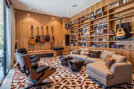 Modern music room with wall-mounted guitars, and cozy seating area.