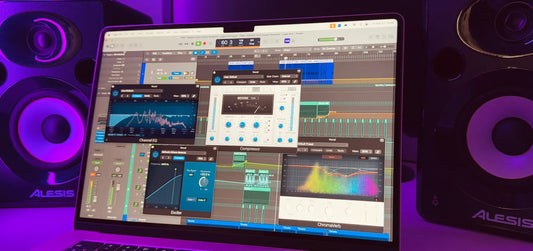 Laptop displaying a digital audio workstation with EQ, compressor, and effects plugins open, surrounded by studio speakers with purple lighting.