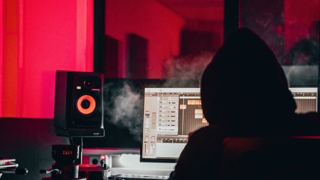 Person in Hoodie mixing their singing in a studio room with speakers and smoke