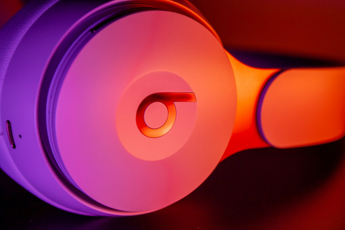 white Headphones resting on a smooth surface