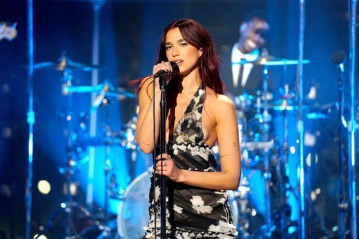 Dua Lipa singing into a mic