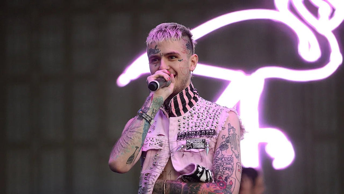 Lil peep smiling and holding up a microphone to his mouth