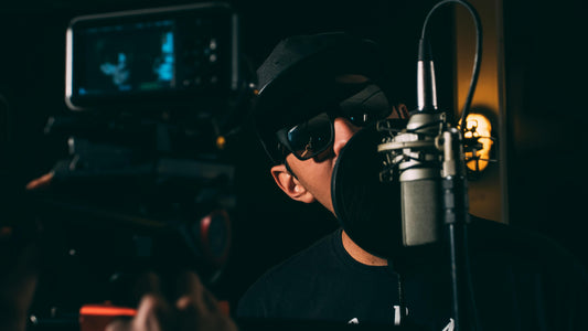 man recording vocals for his music