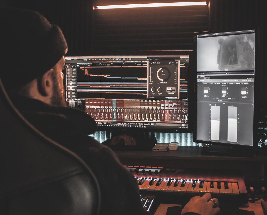 Mixing engineer at his work station working on sitting his vocals within his song mix