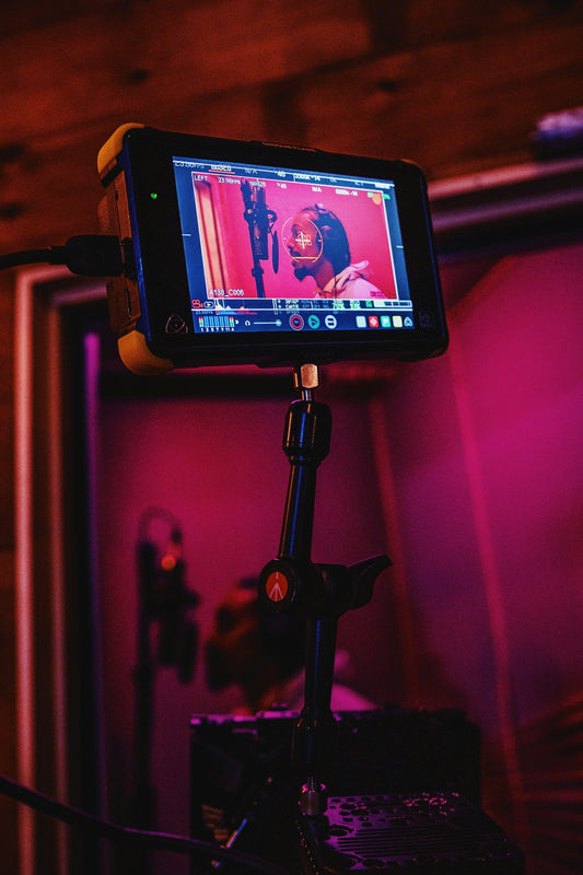 Camera focused on a man recording Hip Hop vocals