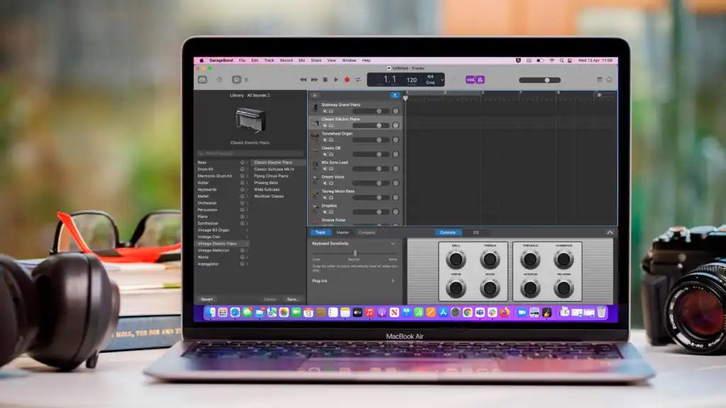 GarageBand on a laptop with a camera on the right and headphones on the left