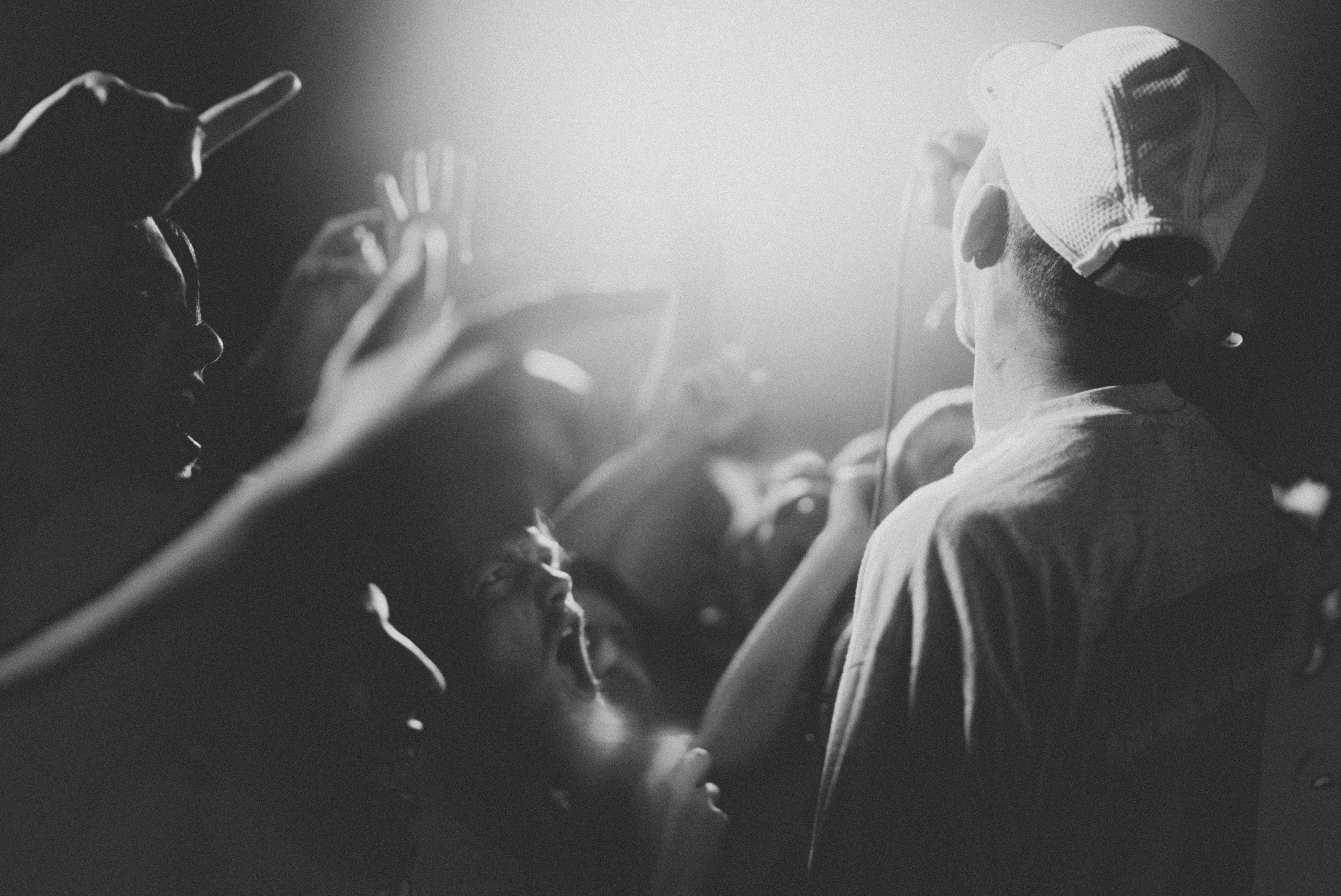 Trap artist in a crowd of people singing