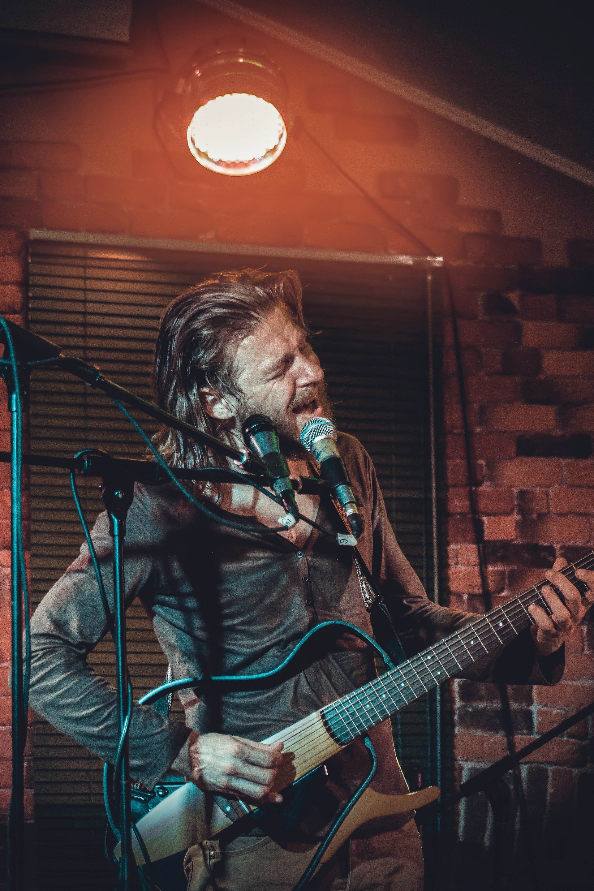 Country singer with a guitar singing into a microphone