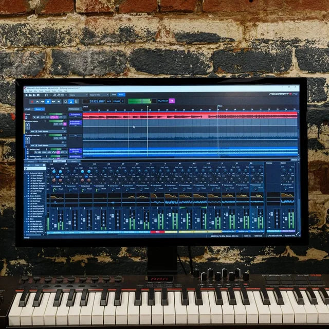 Mixcraft on a monitor and a MIDI keyboard below